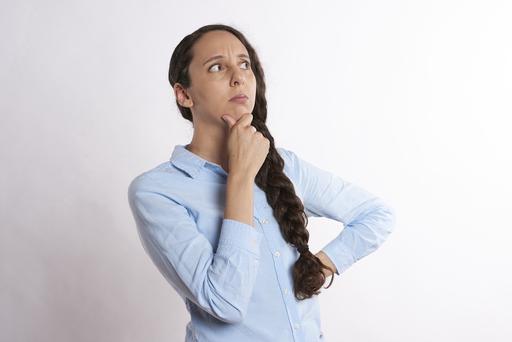 A businesswoman thinking whilst holding her chin